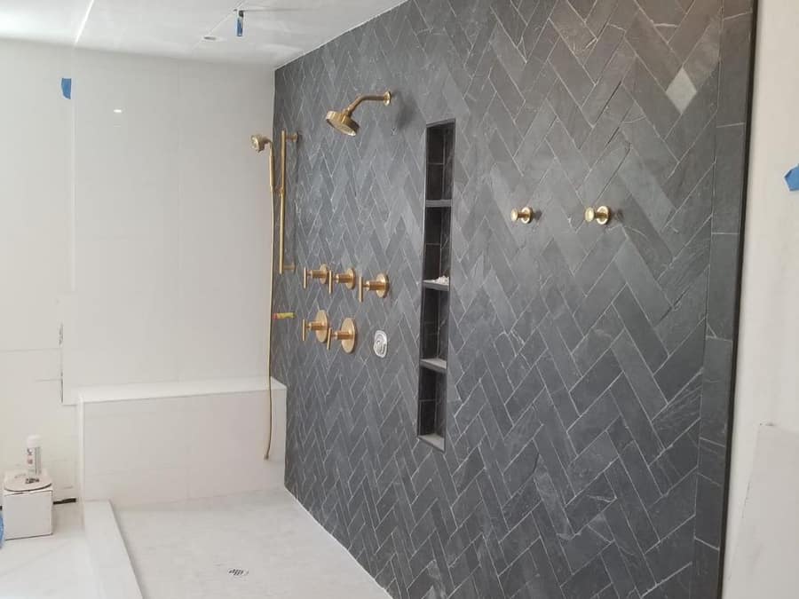 Renovated bathroom with a stone vanity top and tiled shower